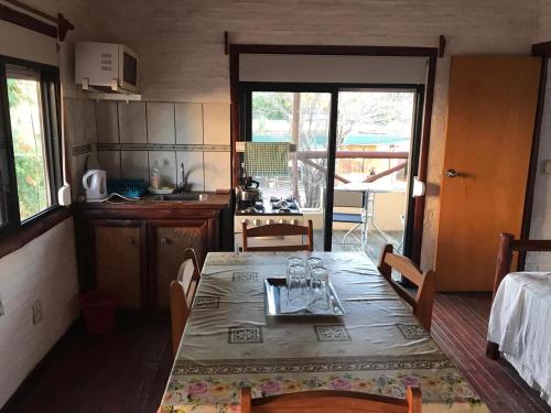 a kitchen with a table and chairs and a kitchen with a table and a table at Apartamentos Céntricos avenida Piria in Piriápolis