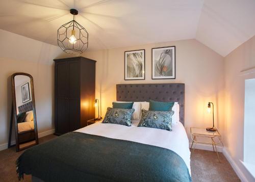 a bedroom with a large bed with two pillows at Host & Stay - Middle Farmhouse in Whitby