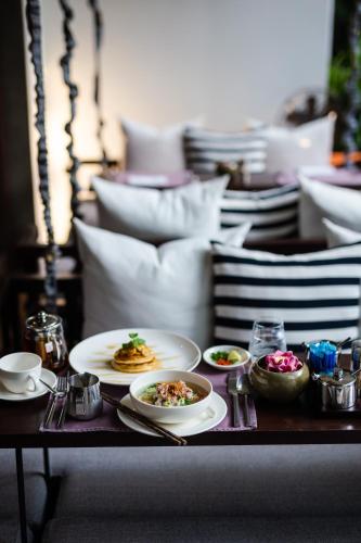 a table with plates of food on top of it at Jaya House River Park Hotel in Siem Reap