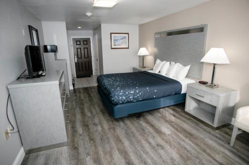 a hotel room with a bed and a flat screen tv at Anchor Beach Inn in Crescent City