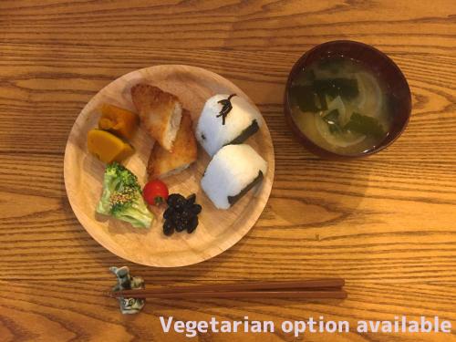 a plate of sushi and vegetables on a wooden table at SHARIN in Kanazawa