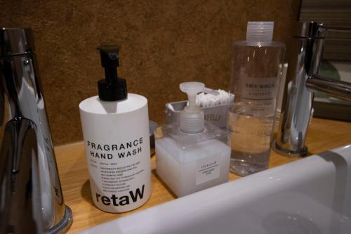 a bathroom counter with a bottle of hand wash and a sink at SHARIN in Kanazawa