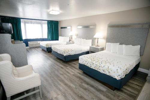 a hotel room with two beds and a chair at Anchor Beach Inn in Crescent City