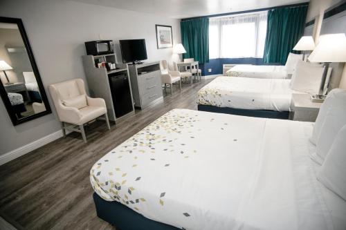 a hotel room with two beds and a television at Anchor Beach Inn in Crescent City