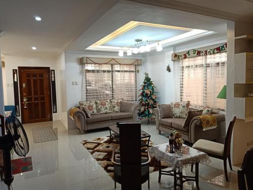 a living room with a christmas tree in it at AJ's Haven Homestay in Cebu City