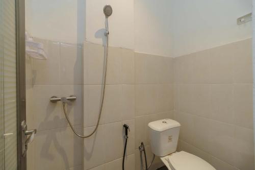 a bathroom with a shower with a toilet at RedDoorz Syariah near RSUD Siti Fatimah Palembang in Palembang
