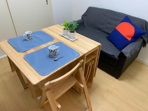 a table and a couch in a living room at QUAYSIDE SAKURAGICHO 201 in Hiranumachō