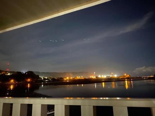 a view of a body of water at night at Hotel y Restaurante Costa del Sol in Mata de Limón