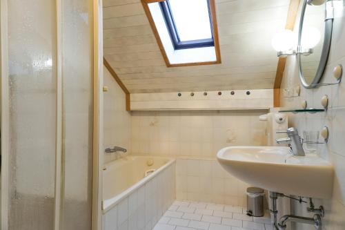 a bathroom with a sink and a bath tub at Monteurzimmer Hochsal in Laufenburg