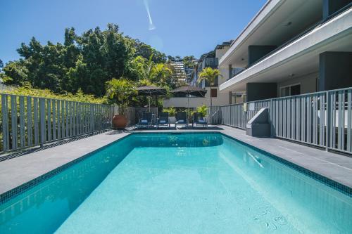a swimming pool in the backyard of a house at Saks on Hastings in Noosa Heads