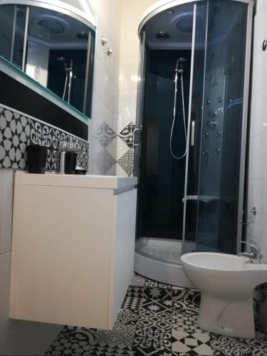 a bathroom with a shower and a sink and a toilet at Sicilia In Miniatura "L'Atelier dell'Etna" in Zafferana Etnea