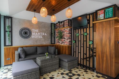 a lobby of a hotel with a couch and a table at The Mantra Hotel Kata Noi in Kata Beach