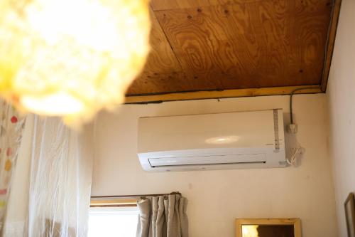 a air conditioner in a bathroom with a ceiling at Guest House Waya in Sapporo