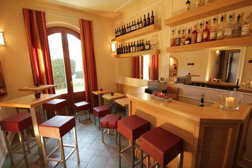 a restaurant with a bar with red stools at Hotel Villa Betania in Florence