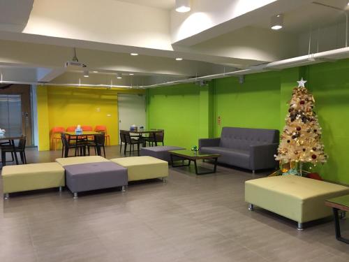 a living room with a christmas tree and couches at 客旅家青年旅館 Travelers Plus in Chiayi City