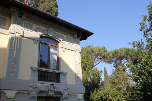 a house with a window and trees in the background at Hotel Villa Betania in Florence