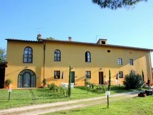 an exterior view of a large yellow house at Farmhouse in Vinci with Swimming Pool Terrace Garden BBQ in Vinci