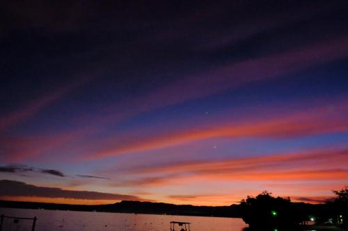 a sunset over a body of water at Jelly Sea Resort in Siquijor