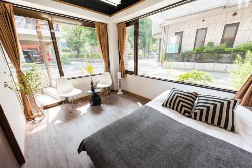 a bedroom with a bed and a large window at TORA HOTEL Tokyo-Rikugienn 寅ホテル 六義園 A in Tokyo