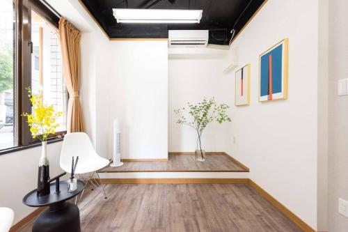 a living room with a table and a chair at TORA HOTEL Tokyo-Rikugienn 寅ホテル 六義園 A in Tokyo