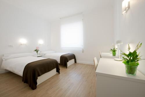 Ein Bett oder Betten in einem Zimmer der Unterkunft NeoMagna Madrid