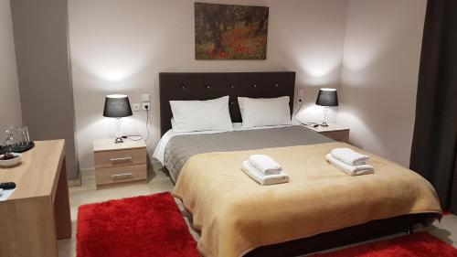 a bedroom with a large bed with two towels on it at Prytanio in Olympia