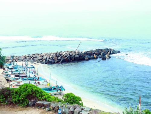 a group of boats parked on a beach at Hotel Sanmark in Ahangama