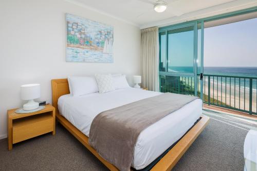 a bedroom with a bed and a window at The Waterford on Main Beach in Gold Coast