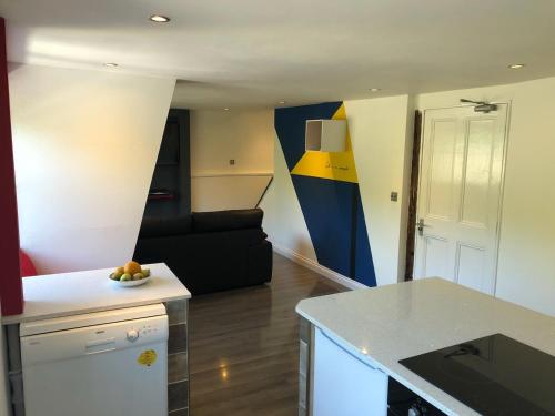 a room with a kitchen and a living room at Old Fleece Apartments in Stroud