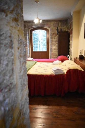 a bedroom with a large bed in a stone wall at Chalet Vecchio Rifugio - Monte Amiata in Castel del Piano
