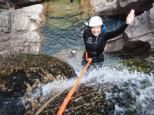 a man is crossing a river on a raft at Águas do Gerês - Hotel, Termas & Spa in Geres