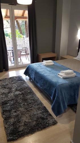 a bedroom with a bed with two towels on it at Prytanio in Olympia