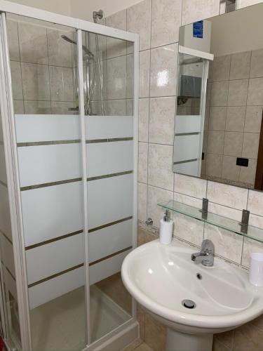 a bathroom with a sink and a mirror at Monolocale Azzurra in Magione