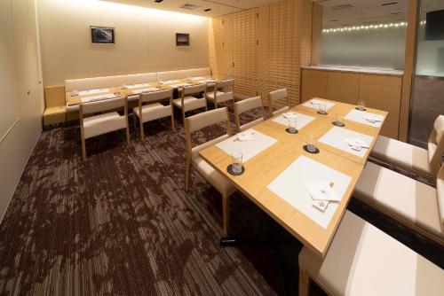 a conference room with long tables and chairs at Hotel Granvia Osaka-JR Hotel Group in Osaka