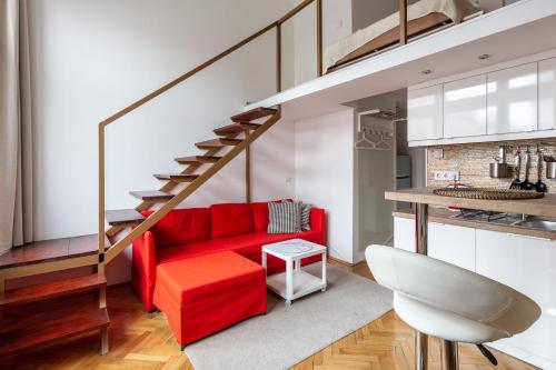 a living room with a red couch and stairs at Dream Home in The Walking Street in Budapest