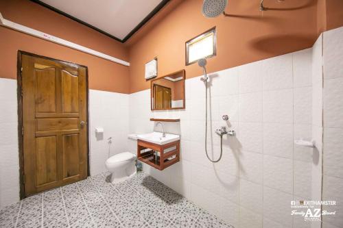 a bathroom with a toilet and a sink at AZ Family Resort in Ngapali