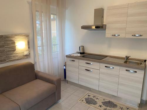 a kitchen with a couch and a sink at L'ancora di Monterosso - Cinque Terre in Monterosso al Mare
