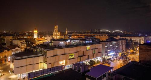 a view of a city at night at Dali Apartments Pupin Palace in Novi Sad