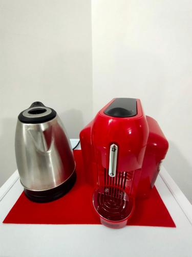 a red coffee maker sitting on a red napkin at la staccionata bianca in Viterbo