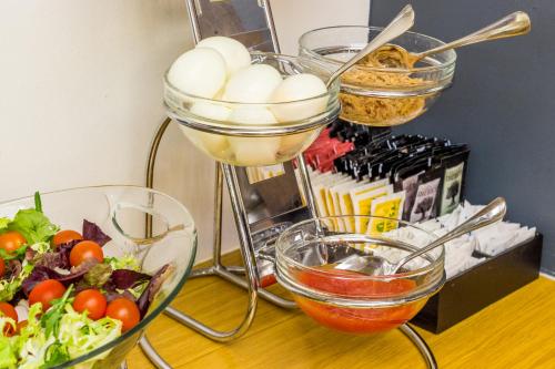 a table with bowls of food and a salad at Hostemplo Sagrada Familia in Barcelona