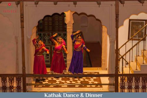 three women performing a dance on a stage at Haveli Dharampura - UNESCO awarded Boutique Heritage Hotel in New Delhi