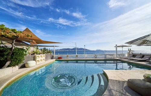 a swimming pool with a view of the water at Le Petit Nice - Passedat in Marseille