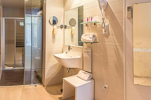 a bathroom with a sink, toilet and bathtub at Hostemplo Sagrada Familia in Barcelona