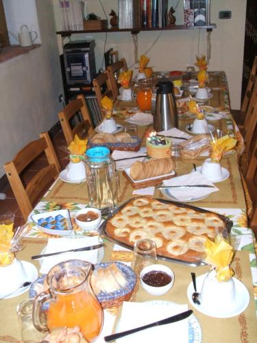 a long table with food and drinks on it at Casetta Francini in Civitella Marittima