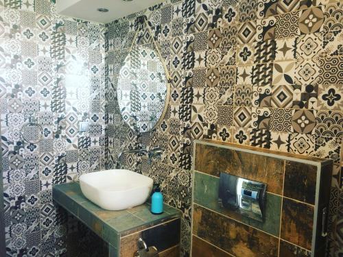 a bathroom with a sink and a mirror on a wall at Zinozis Beach Apartments in Vourvourou
