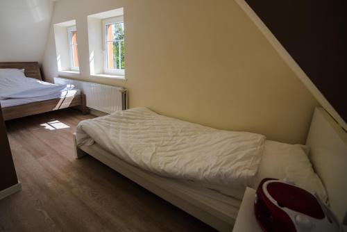 ein kleines Schlafzimmer mit einem Bett und einem Fenster in der Unterkunft Die Kleine Villa in Zimmert