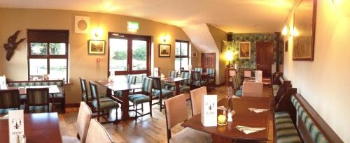 a dining room with tables and chairs in a restaurant at Nanny Quinn's Apartment in Killucan