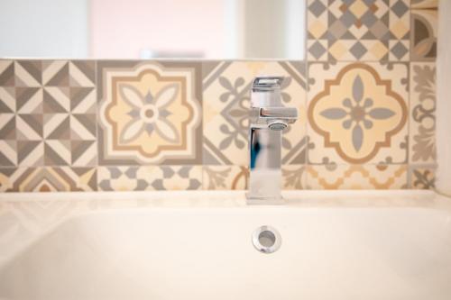 a bathroom sink with a faucet on top of it at Zythogite, 23 personnes, 9 chambres, 6 salles de bain, bbq, jacuzzi, jardin, billard in Tintigny