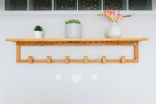 a wooden shelf on a wall with vases and plants at Zythogite, 23 personnes, 9 chambres, 6 salles de bain, bbq, jacuzzi, jardin, billard in Tintigny