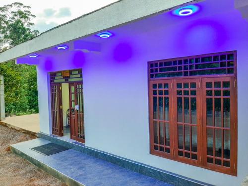 a model of a house with purple lights on it at Heaven Hills Guest House in Maskeliya
